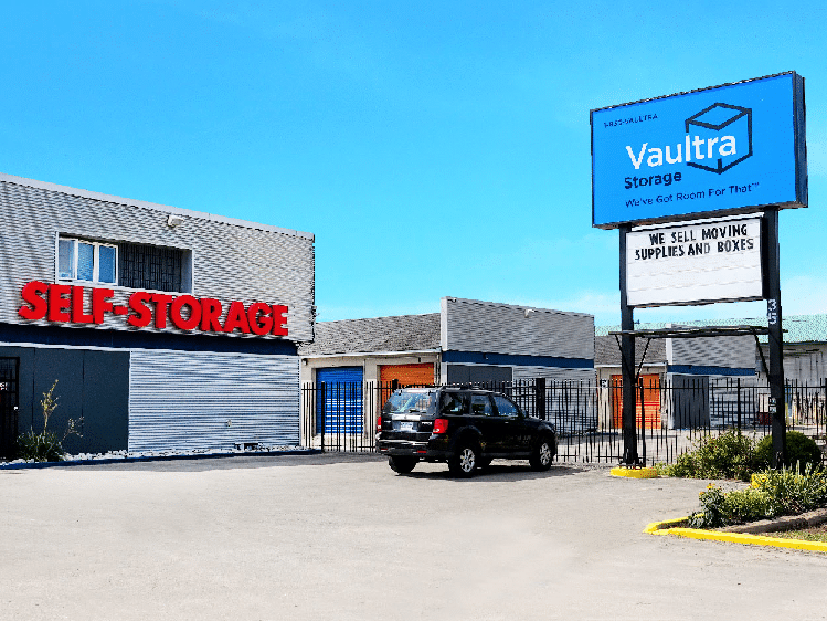 Person using Vaultra Storage moving bins outside Vaultra Storage Brantford facility