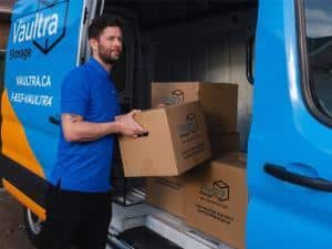 Visual representation of the pros and cons of moving items yourself versus hiring professional movers, featuring a Vaultra Storage door-to-door mover assisting with the moving process, emphasizing convenience and expertise.
