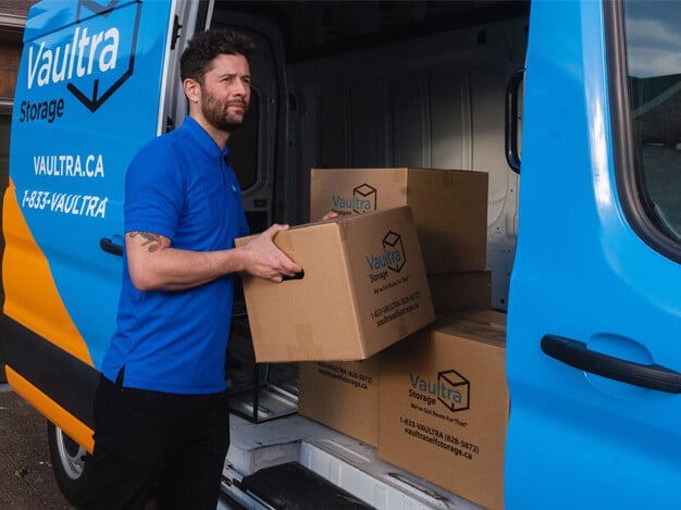 Visual representation of the pros and cons of moving items yourself versus hiring professional movers, featuring a Vaultra Storage door-to-door mover assisting with the moving process, emphasizing convenience and expertise.