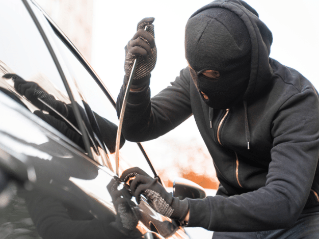 Thief stealing a car