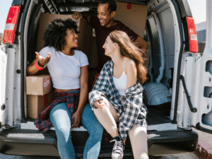 Image depicting a student packing up belongings into boxes for summer storage with Vaultra Storage, showcasing convenience and affordability for students during summer break.