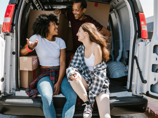 Image depicting a student packing up belongings into boxes for summer storage with Vaultra Storage, showcasing convenience and affordability for students during summer break.