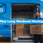 Vaultra mover holding a box in front of a Vaultra Storage moving van