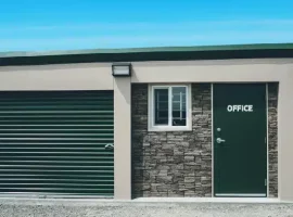 Exterior view of Vaultra Storage Sault Ste. Marie, highlighting a modern and secure storage facility with a welcoming entrance and ample parking space.