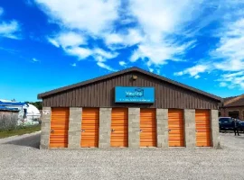 Exterior view of Vaultra Storage Port Perry, highlighting a modern and secure storage facility with a welcoming entrance and ample parking space.