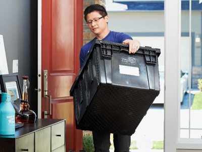 Customer using one of Vaultra Storage's durable moving boxes to move their stuff